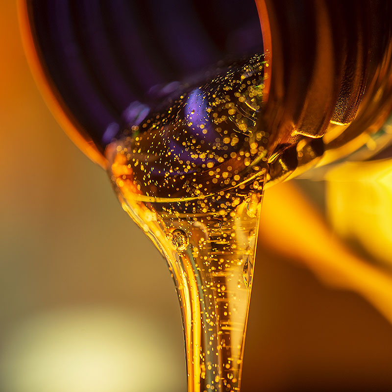 Image of lubricant being poured from a vessel